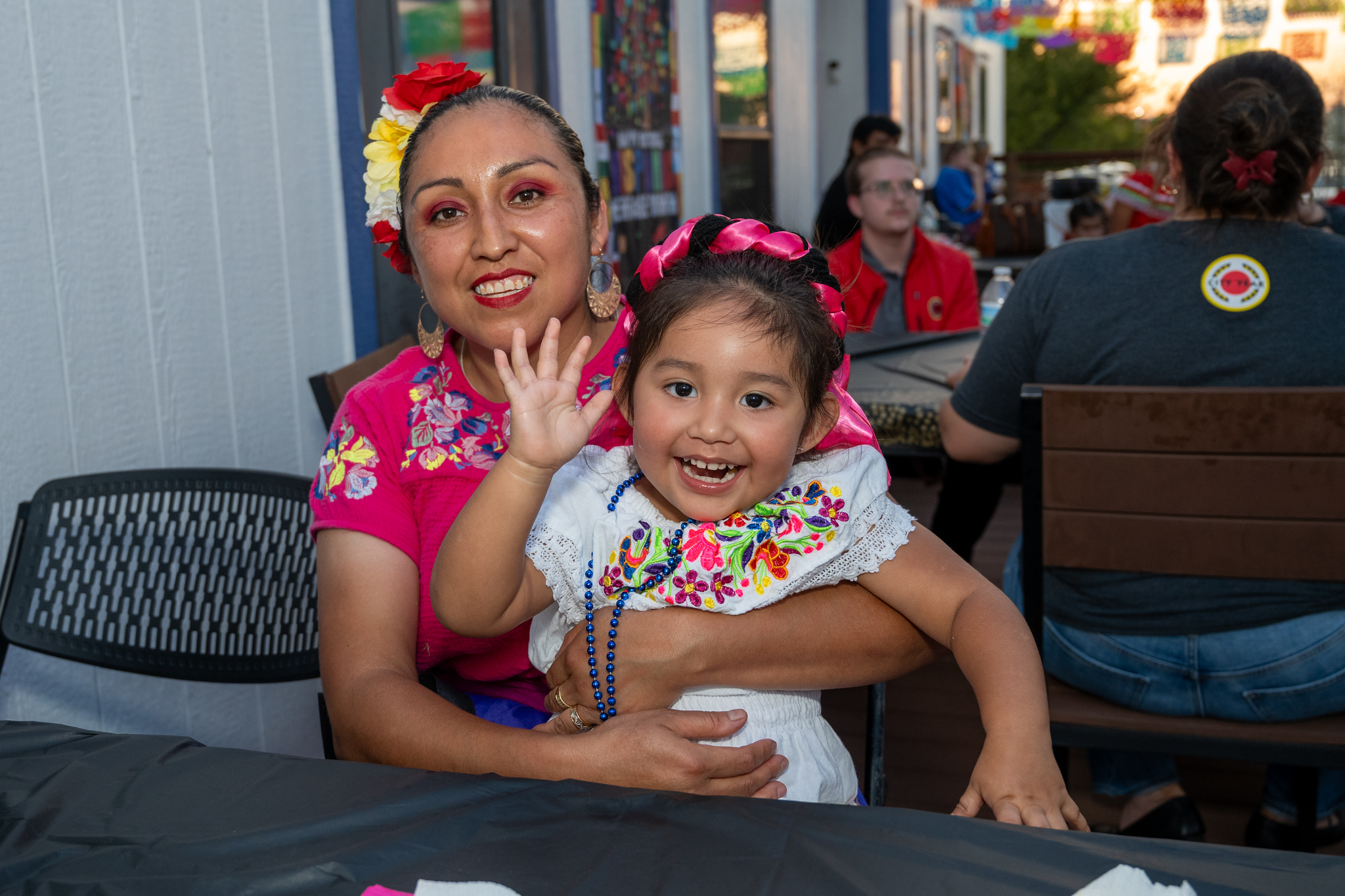 woman and child in brightly dressed clothes celebrating